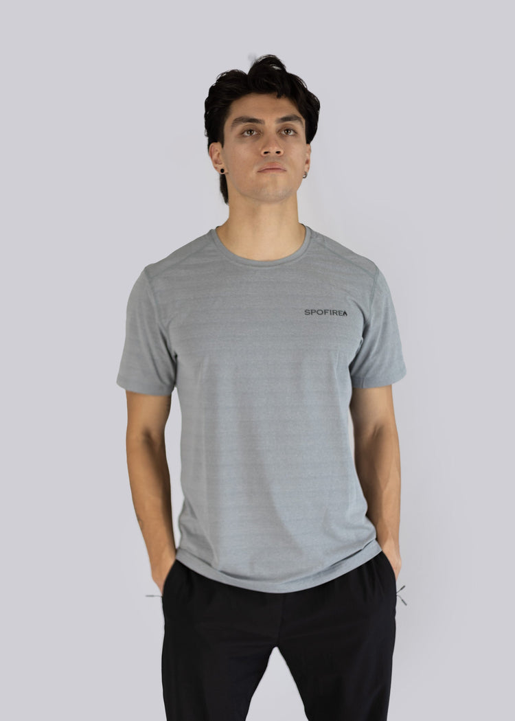 Man wearing a gray t-shirt with the Spofire logo on a light gray background
