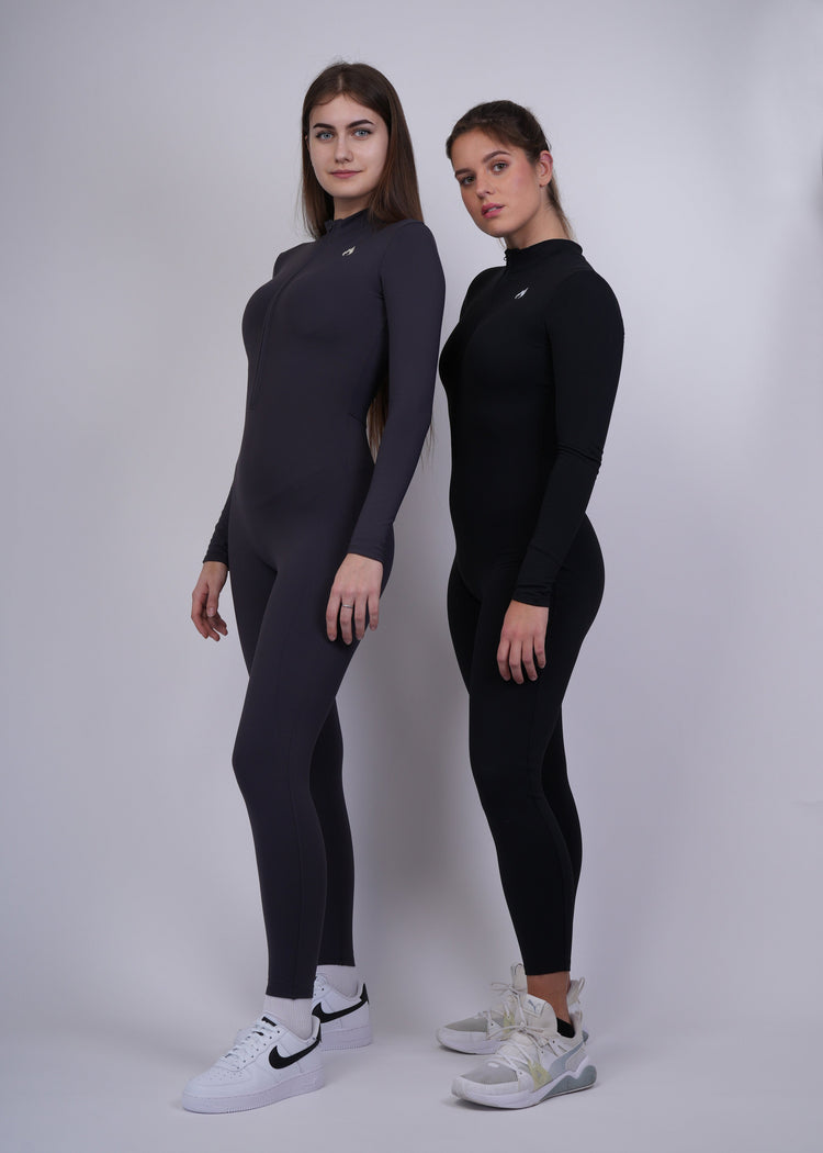 Two Models wearing black and graphite  full-body suits on a white background 